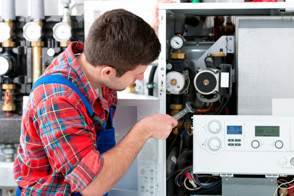 Heating technician repairing boiler controls in Cupertino