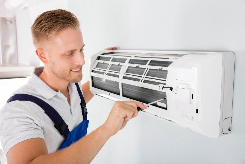HVAC technician maintaining a ductless air conditioner in Cupertino