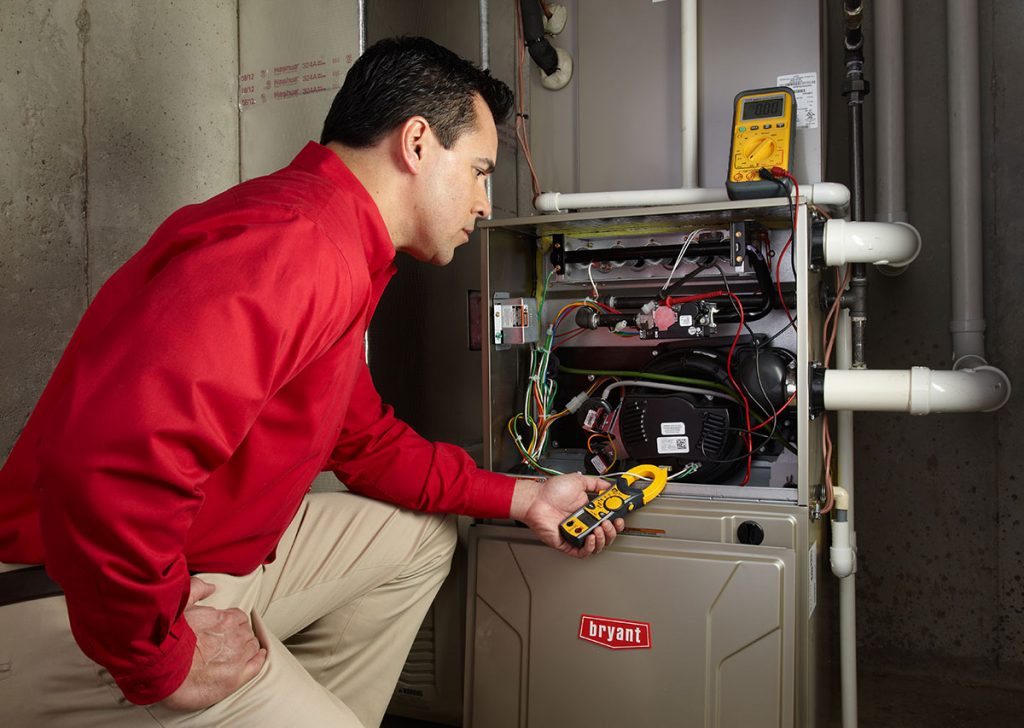 Heating technician diagnosing a furnace repair in Cupertino