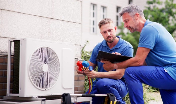 HVAC technicians installing an outdoor air conditioning unit in Cupertino